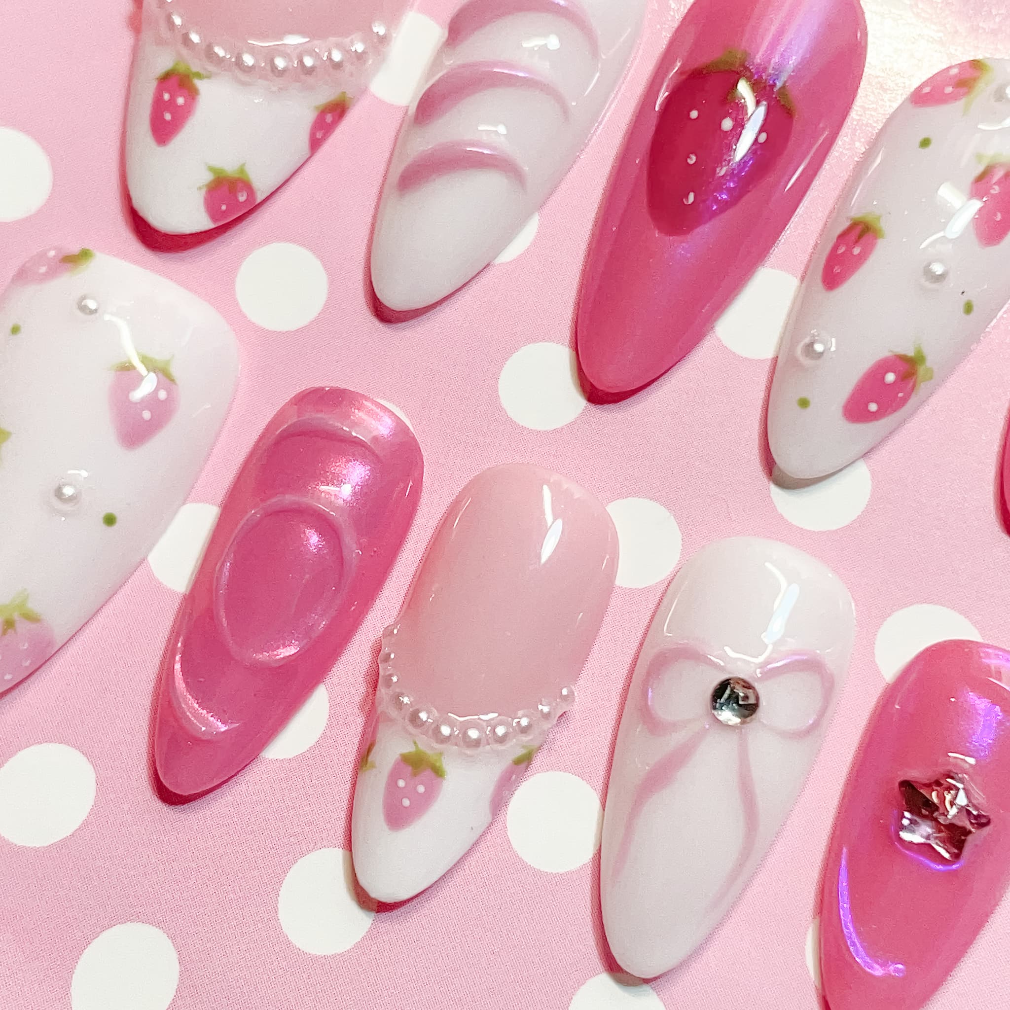 medium length pink almond press on nails with strawberry design