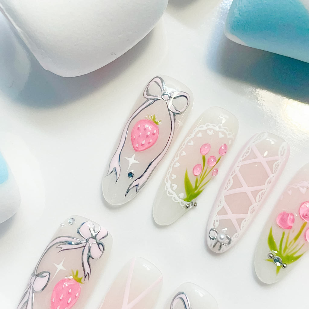 long length light pink oval press on nails with strawberry/lace and bow design