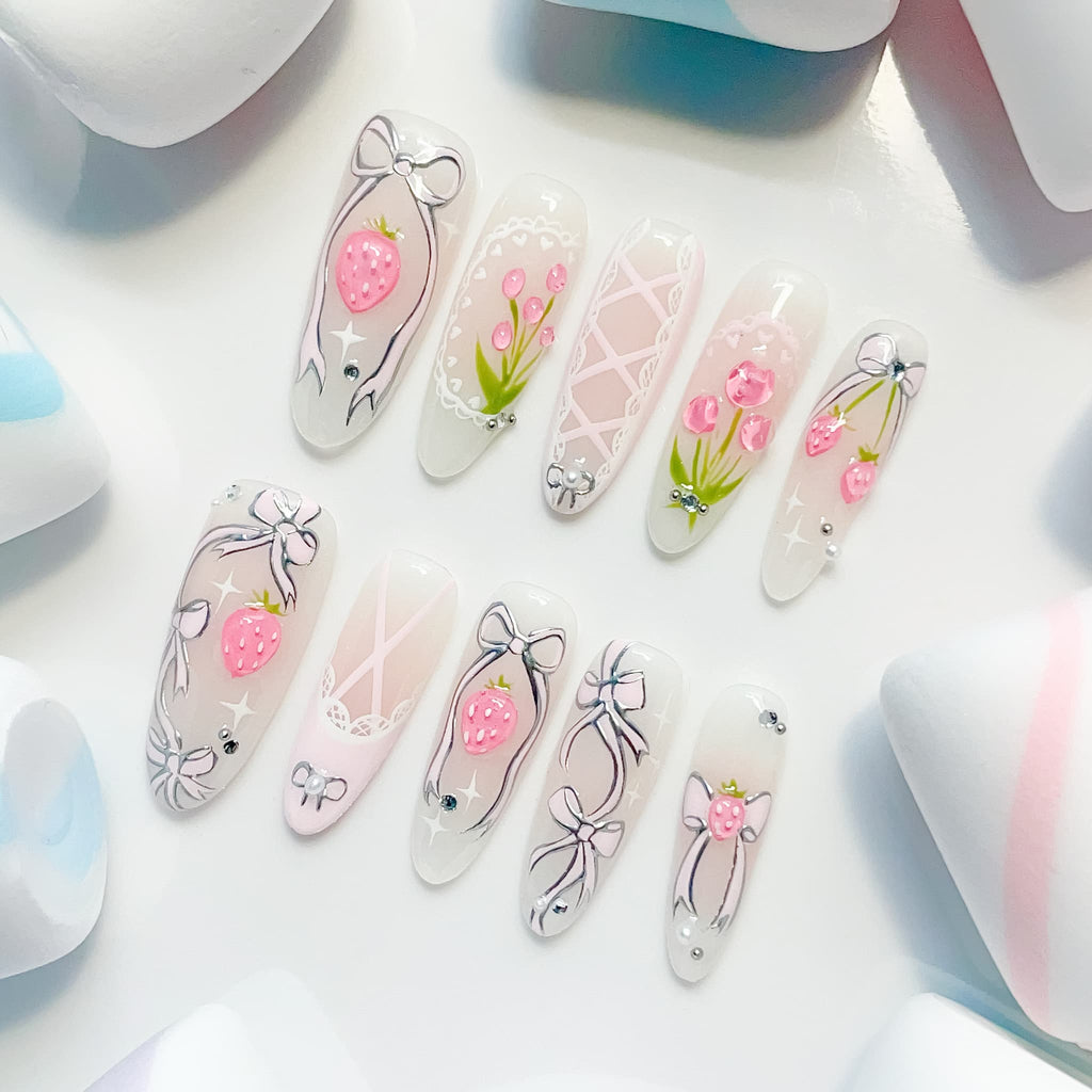 long length light pink oval press on nails with strawberry/lace and bow design