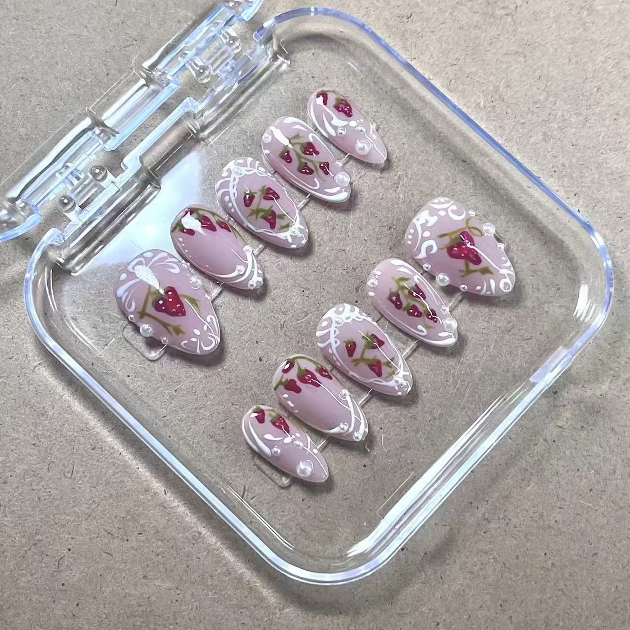 short length red almond press on nails with strawberry design