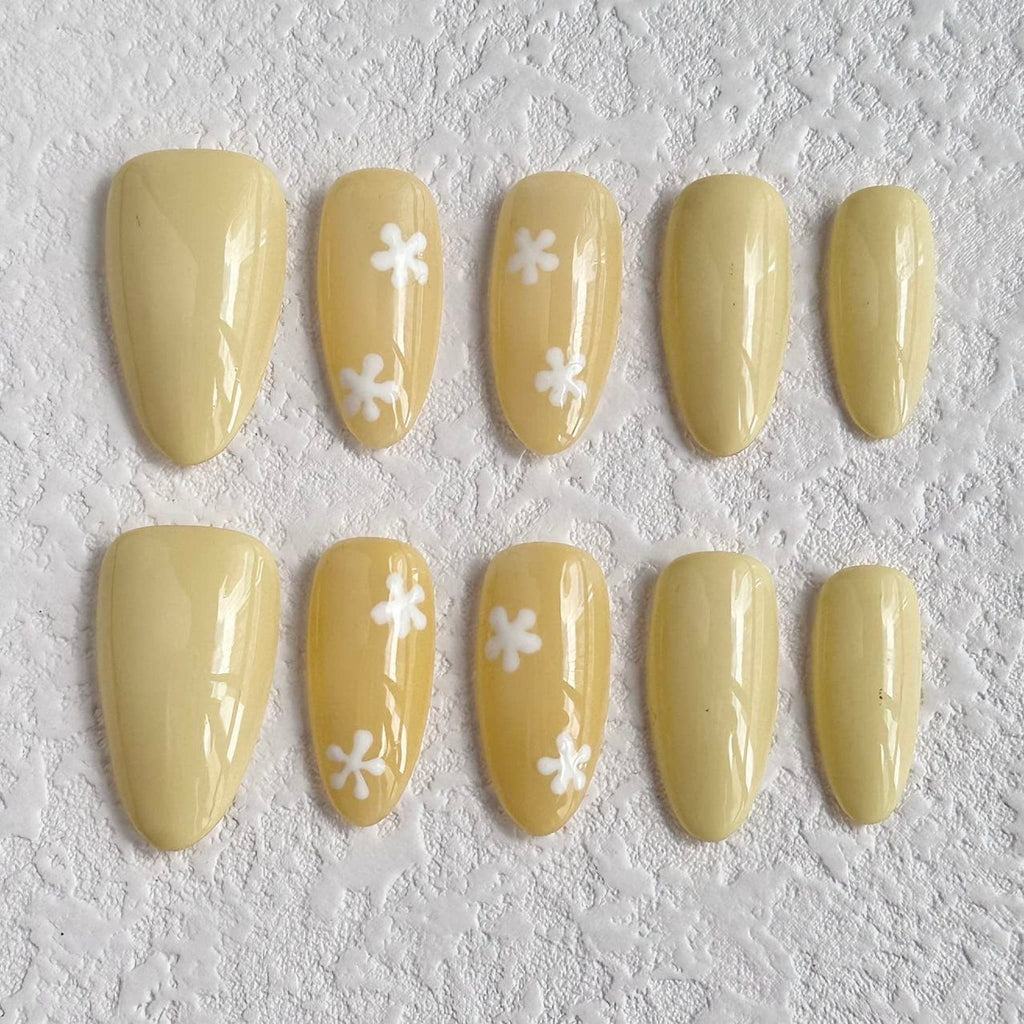 medium length moccasin almond press on nails with daisy pattern 