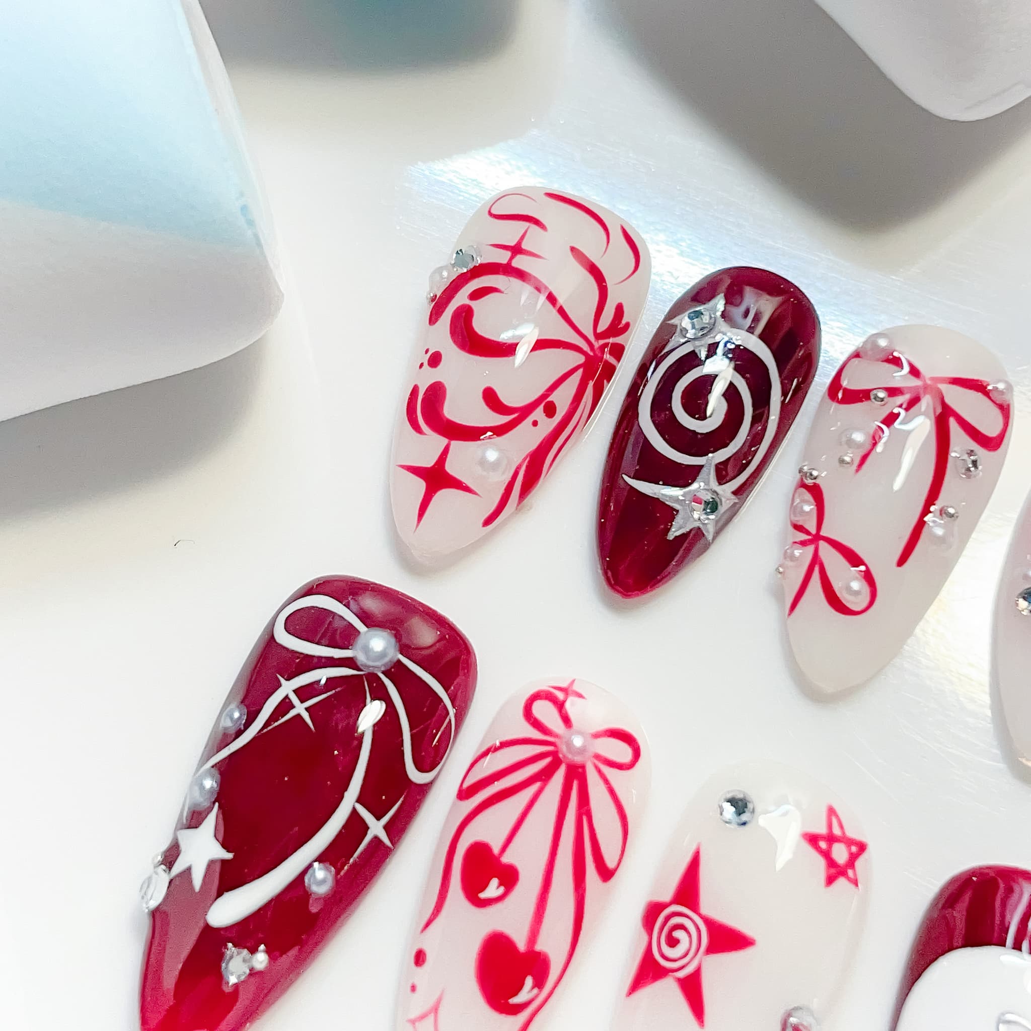medium length crimson almond press on nails with cherry design