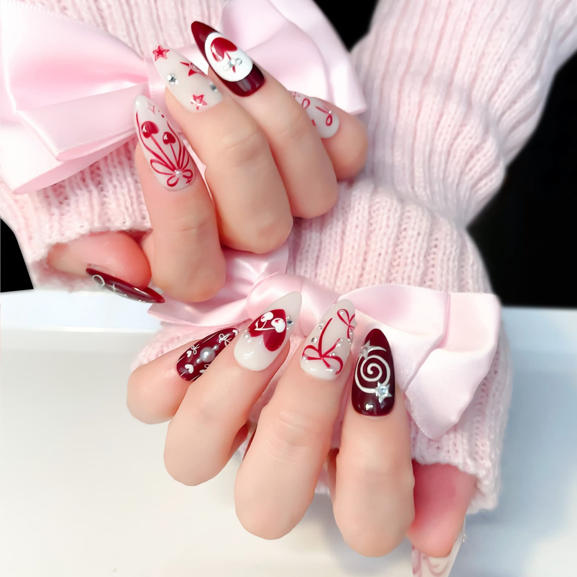 medium length crimson almond press on nails with cherry design