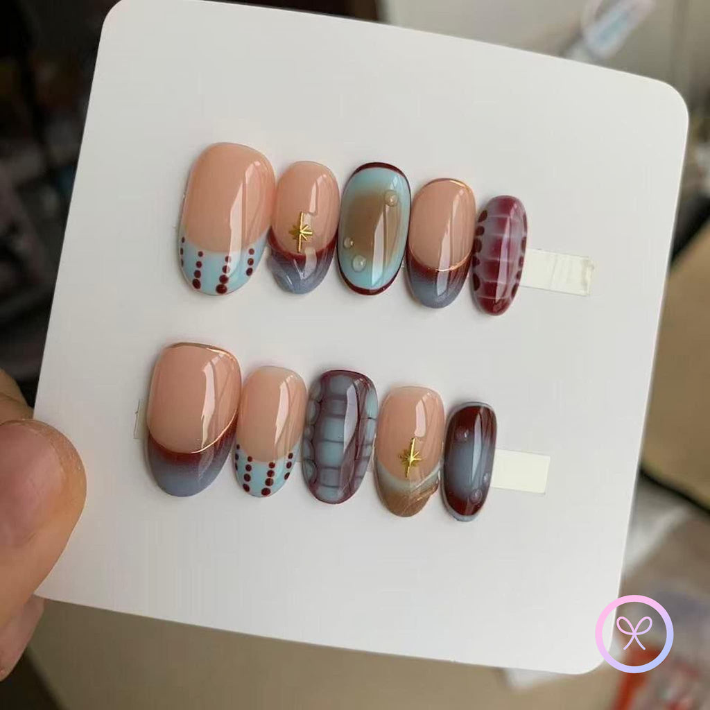 abstract nude glossy short oval press on nails with dot linework , bloom scales and star charms