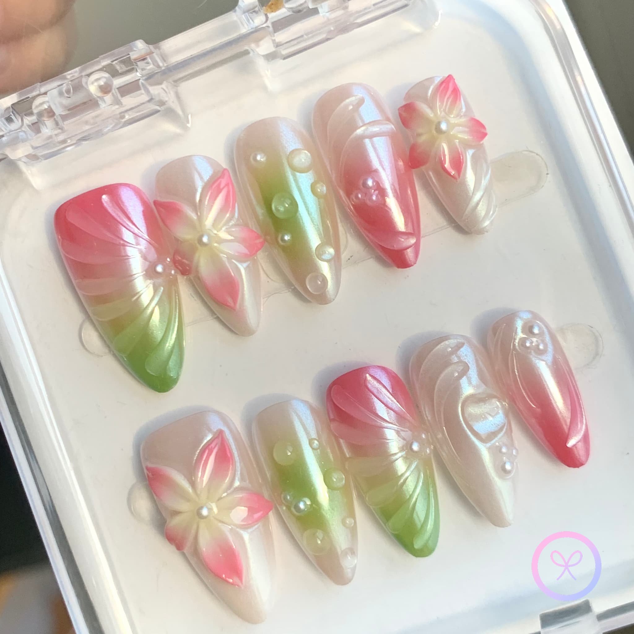 elegant pink iridescent medium almond press on nails with embossed flowers and water droplets and swirls
