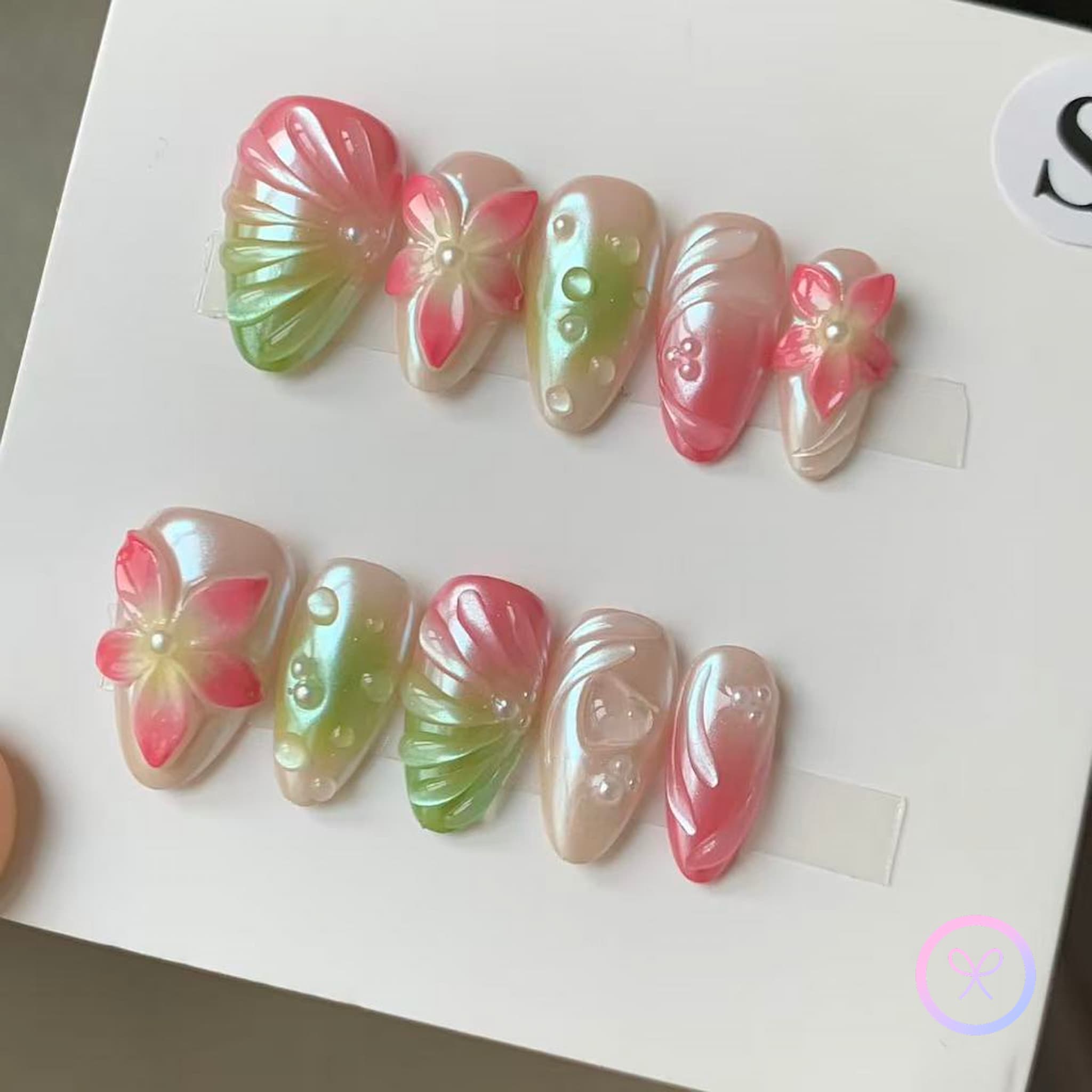 elegant pink iridescent short almond press on nails with embossed flowers and water droplets and swirls