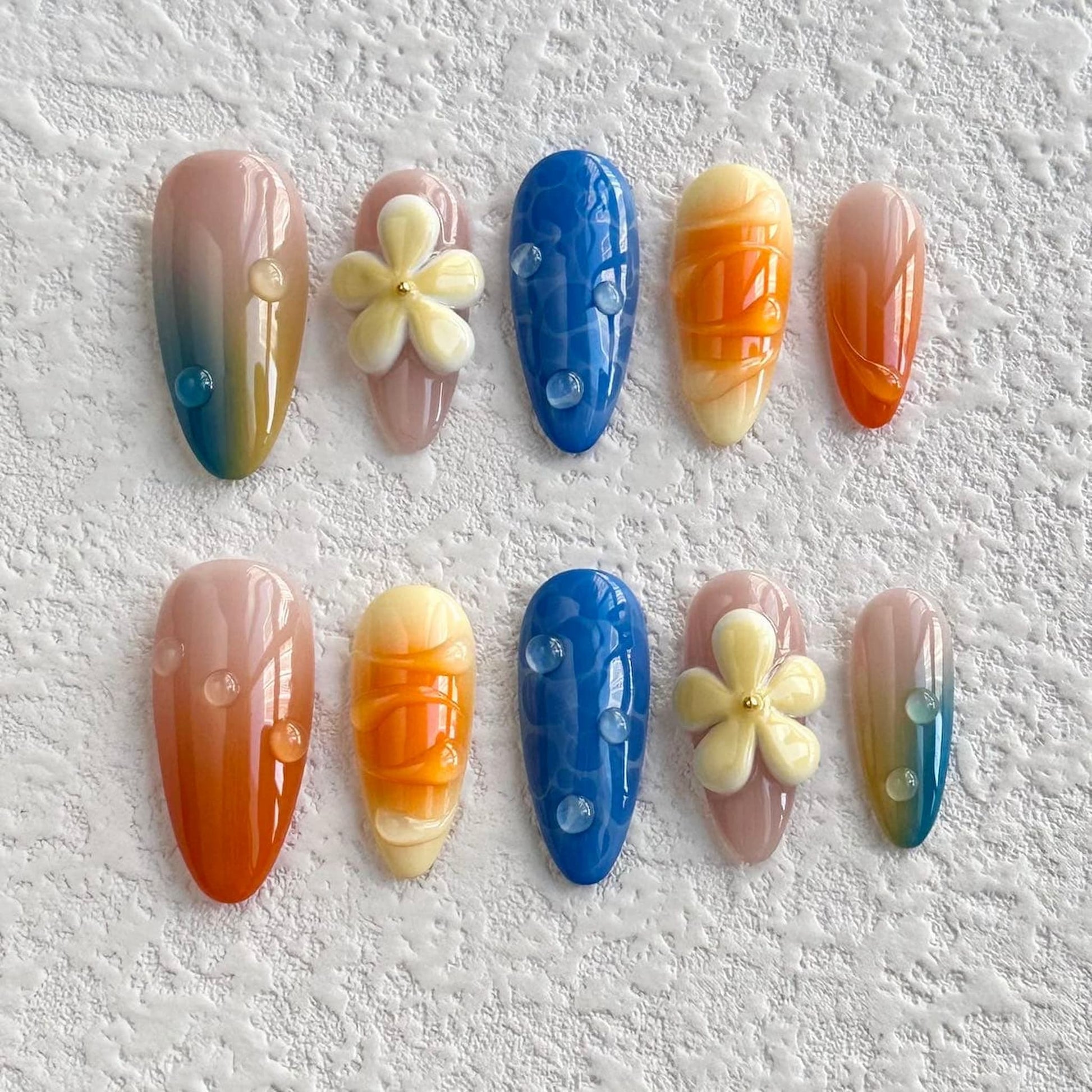 medium orange almond press on nails with yello flowers and water droplets design