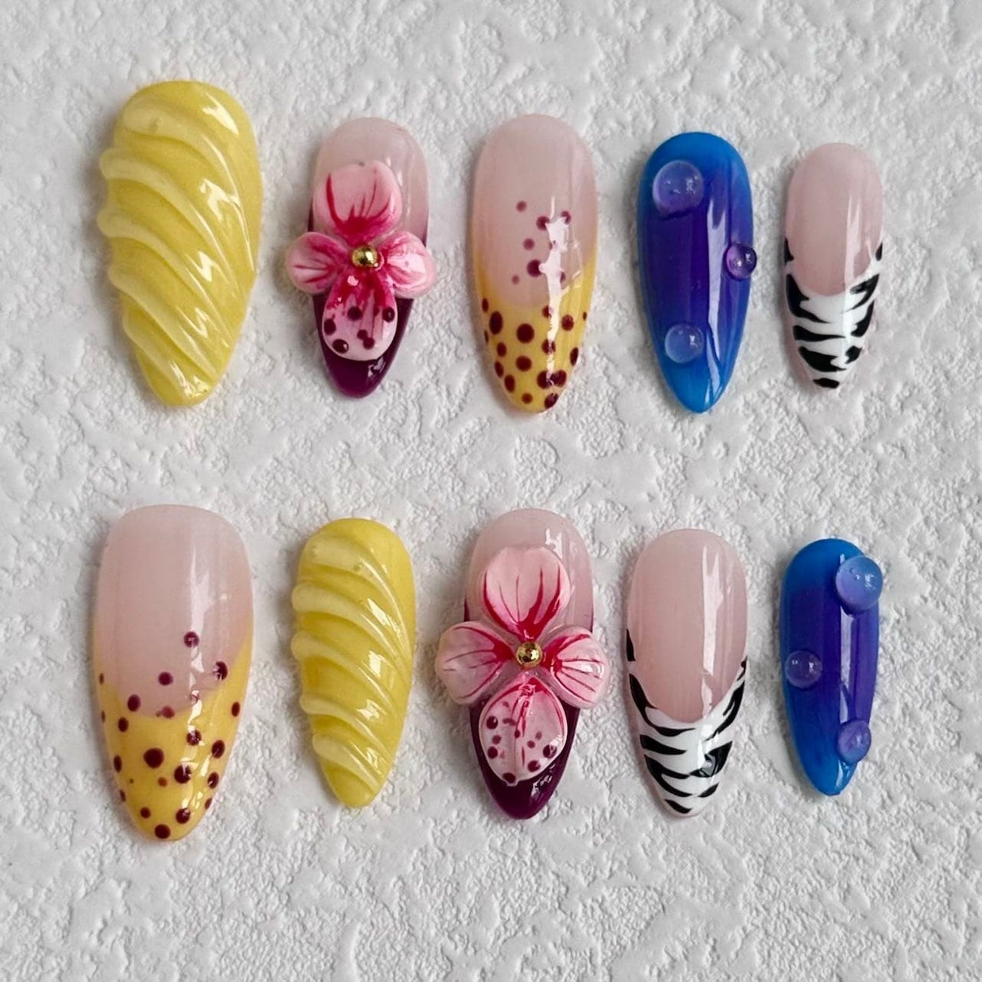 medium length yellow almond press on nails with abstract design and animal print