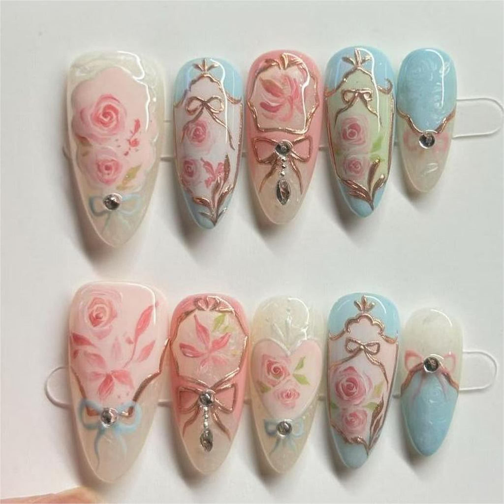 medium length light pink almond press on nails with rococo style design