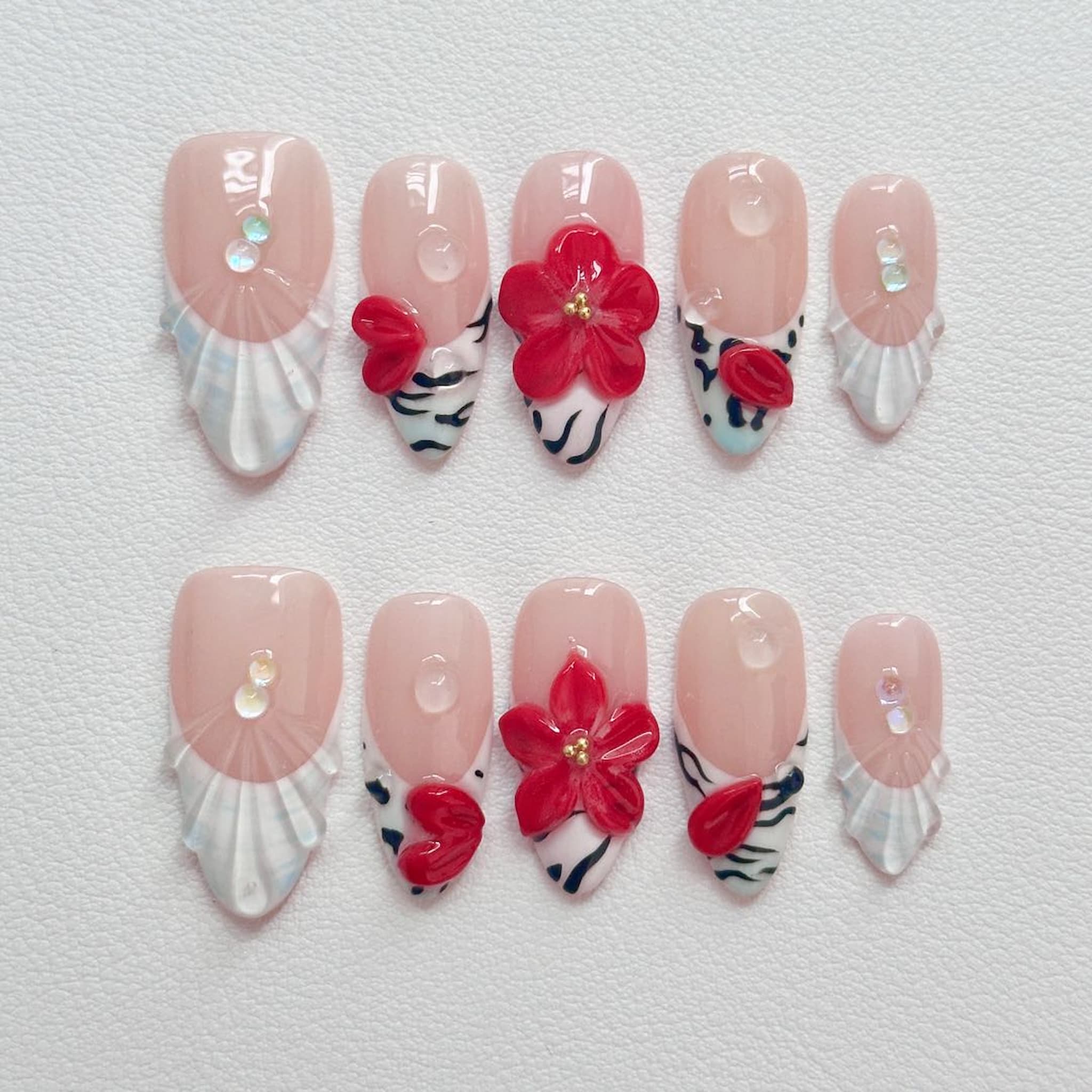 medium length white almond press on nails with zebra print designs and red flowers